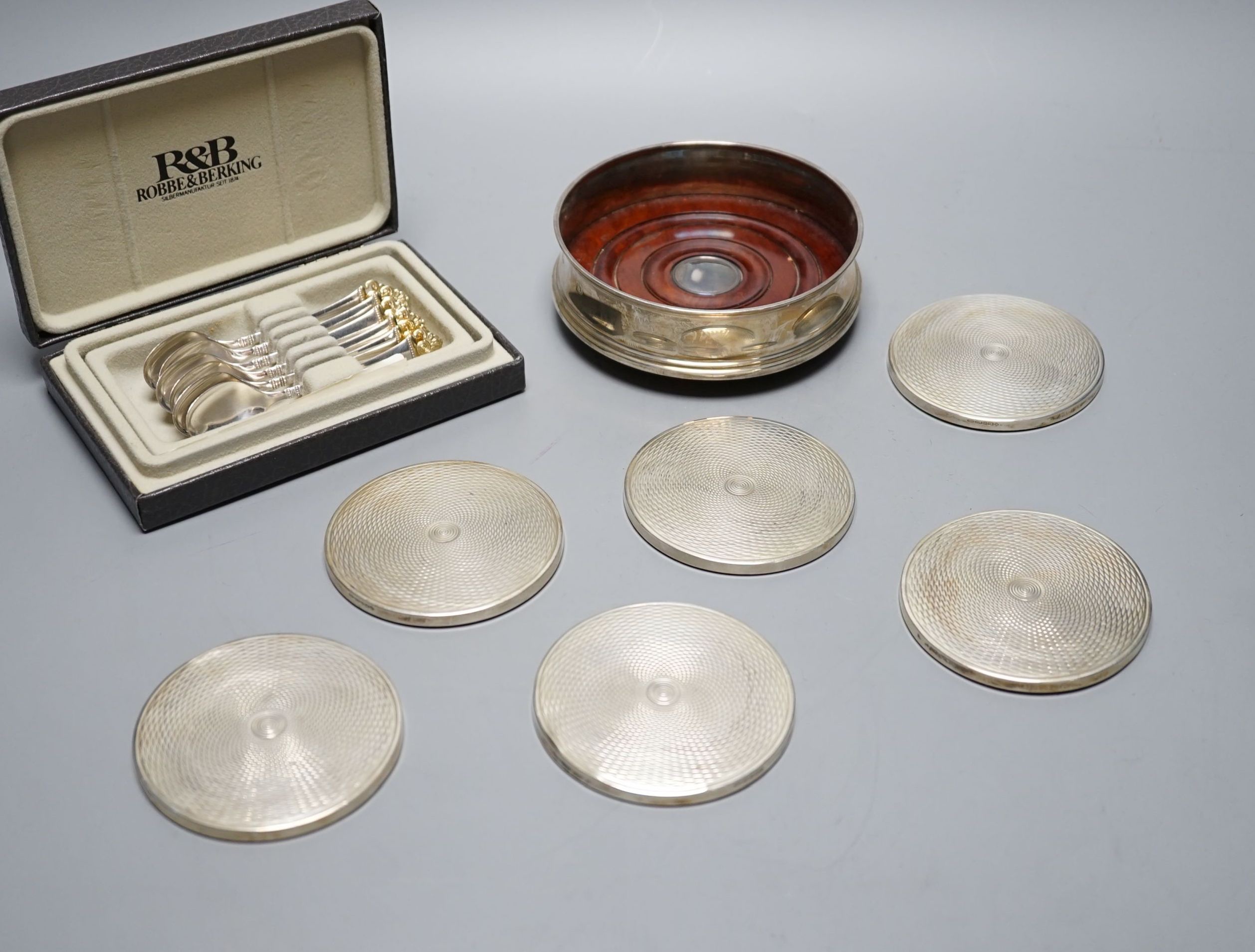 A cased set of six German 800 standard teaspoons by Robbe & Berking, a set of six silver mounted glass coaster and a modern silver mounted wine coaster.